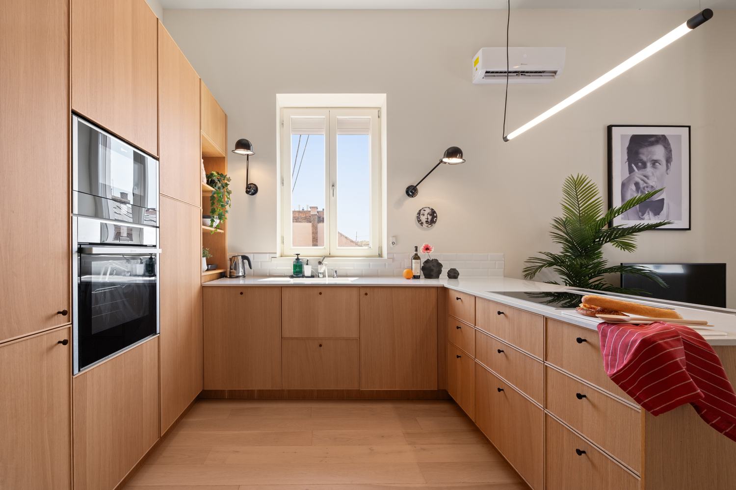 Warm oak kitchen with vintage-style framed photography